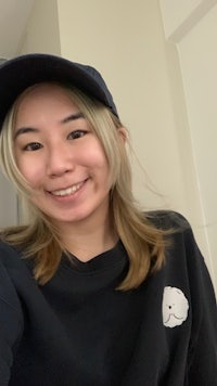 a woman wearing a black hat and a black sweatshirt